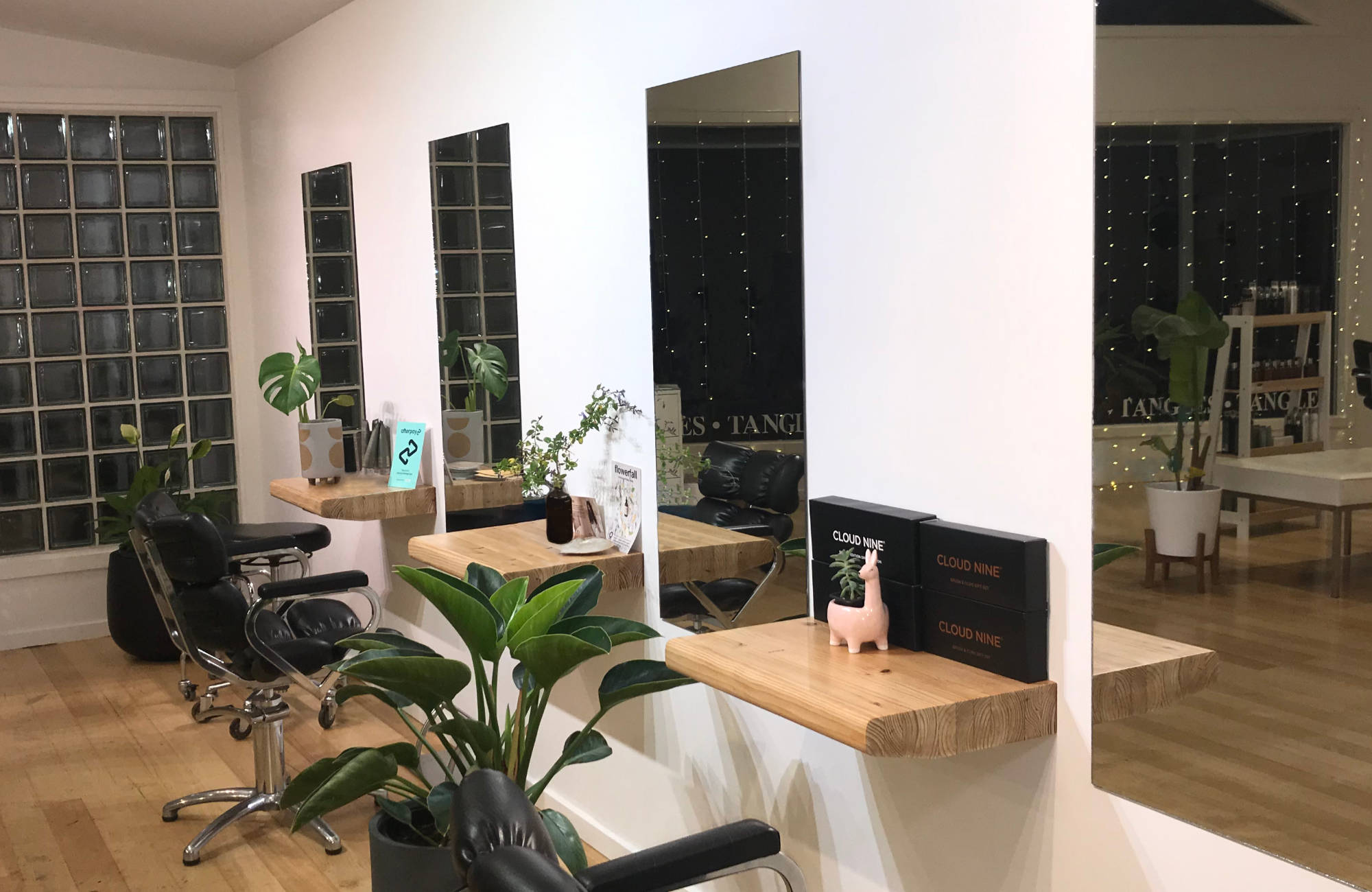 Hairdressing mirrors reflecting window lights at Tangles hair salon